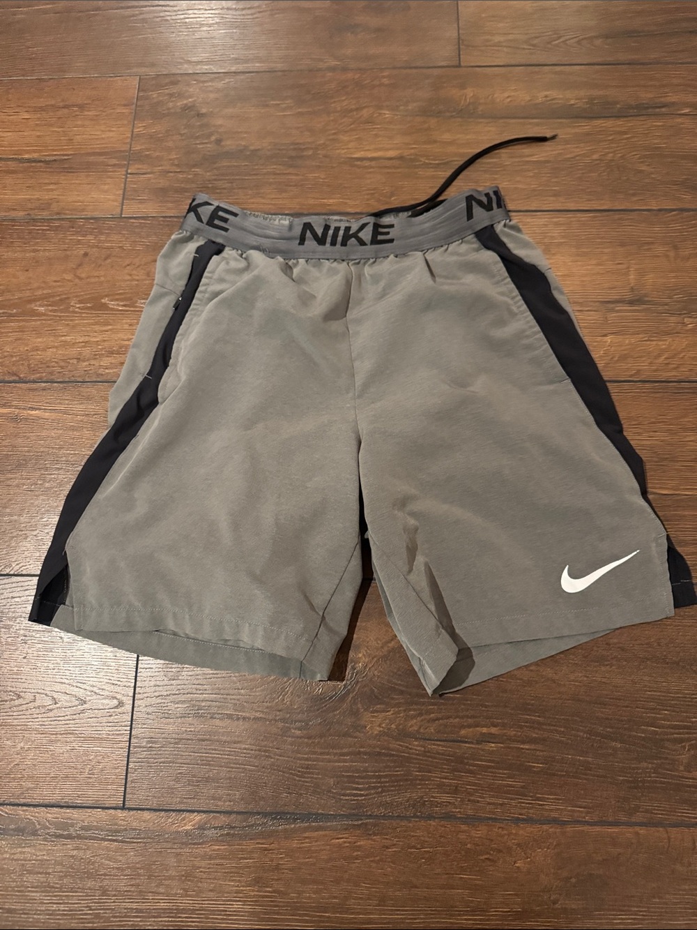 Nike Men's Gray Athletic Shorts with Black Panels and White Swoosh